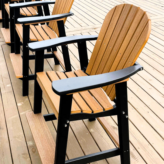 Wooden chairs with black armrests on a wooden deck