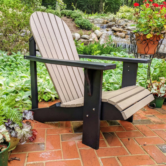 Adirondack chair on a patio with garden and waterfall in the background