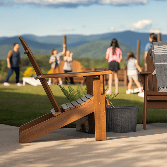 Wooden chair on a patio with people and mountains in the background